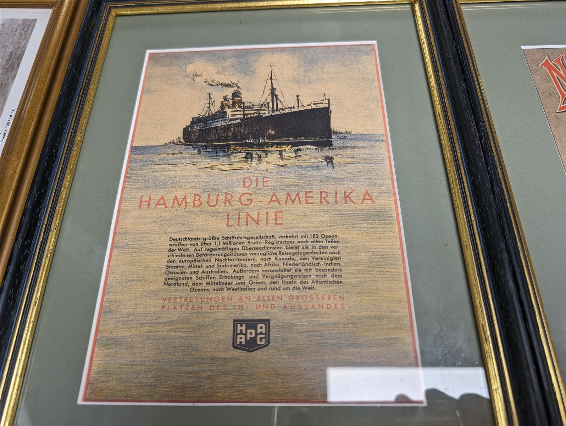 Two framed German shipping prints, together with a framed black and white postcard of United States Lines S.S. Leviathan