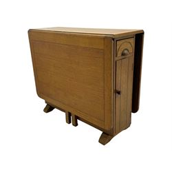 Early 20th century oak drop-leaf table, in the style of Harris Lebus, featuring rectangular top over central pedestal base, with two drawers and two cupboards, on gateleg supports