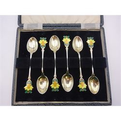 Set of six silver coffee spoons, each with enamelled daffodil decoration to terminal, hallmarked Turner & Simpson Ltd, Birmingham 1938, contained within fitted case