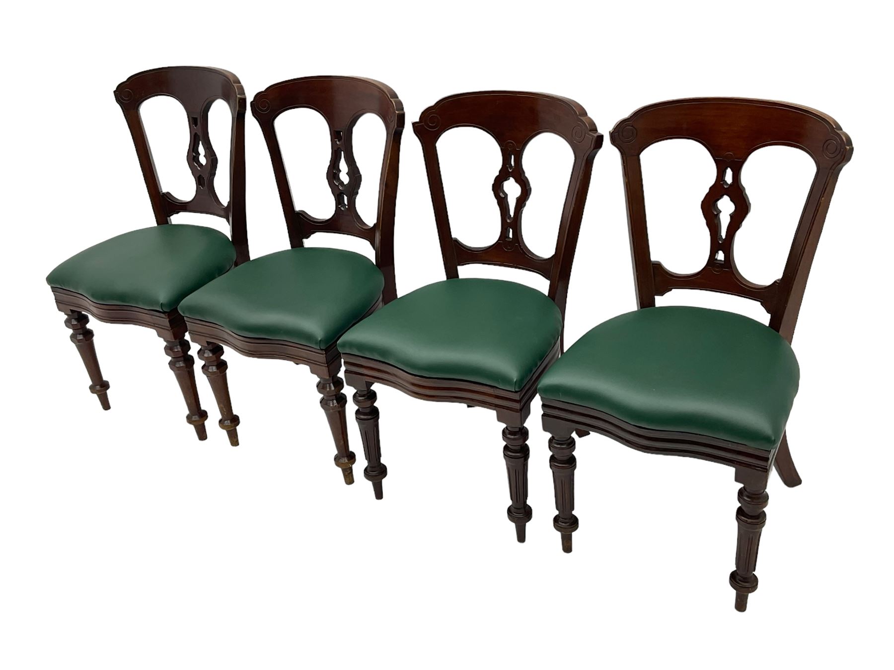 Matched set of twelve Victorian mahogany dining or boardroom chairs, the shaped cresting rail decorated with scrolled decoration, upholstered drop-on seats upholstered in green fabric, on turned supports  