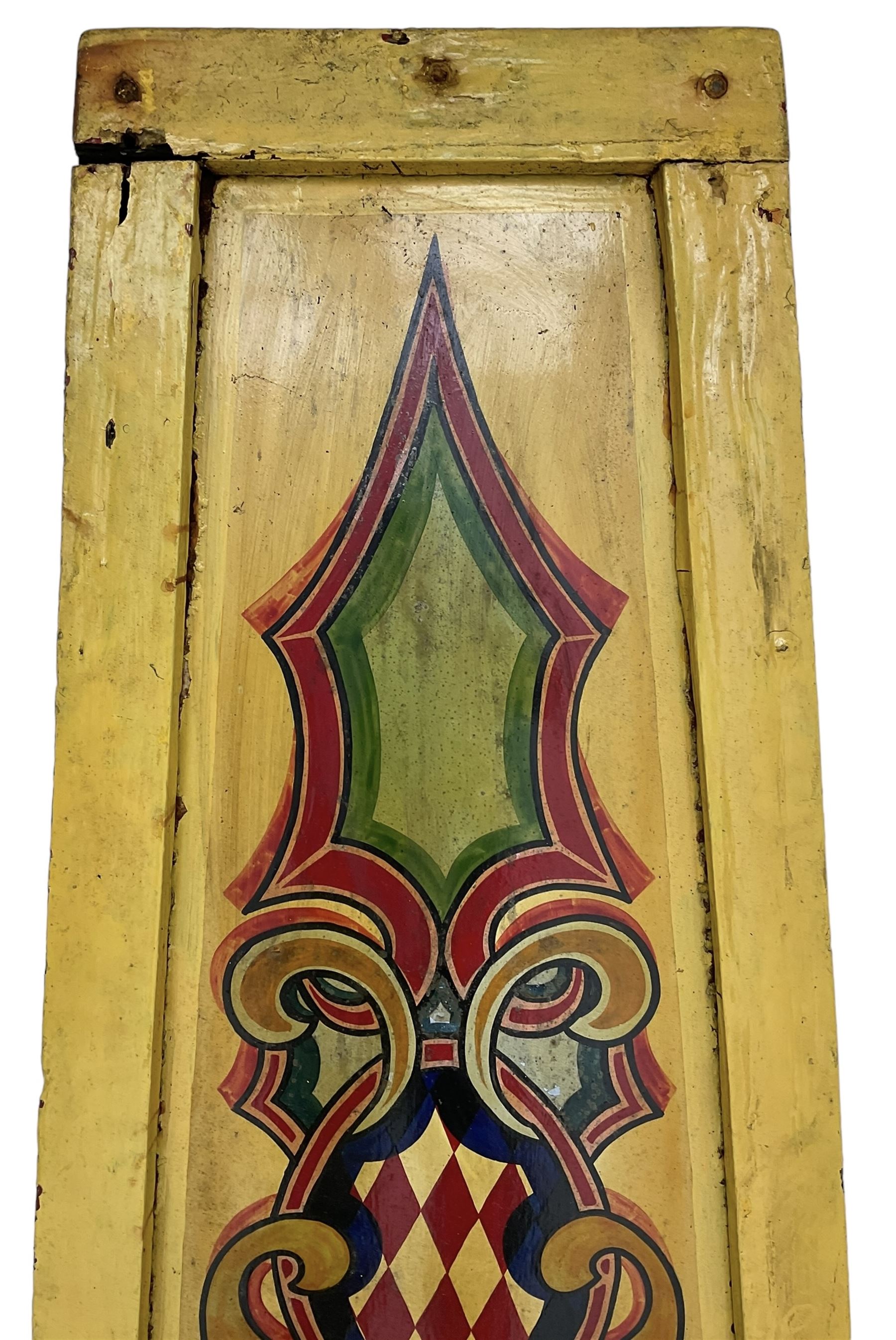 Two early 20th century fairground 'Chair-O-Plane' panels, wooden framed with sheet metal panels, painted in yellow with scrolled cartouche decoration in red, gold and green