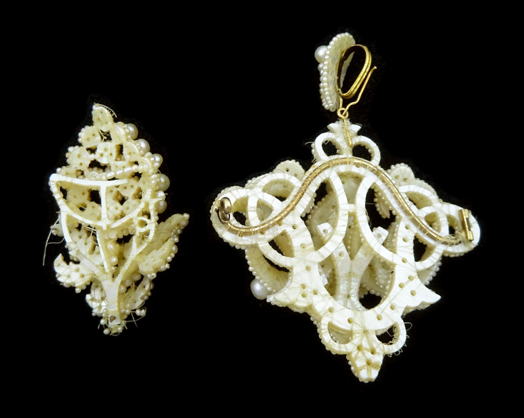 19th century seed pearl knot pendant brooch, of scrolling knot design suspended from a detachable matching bail, mounted to mother of pearl backing, together with a section designed as a bunch of grapes (2)