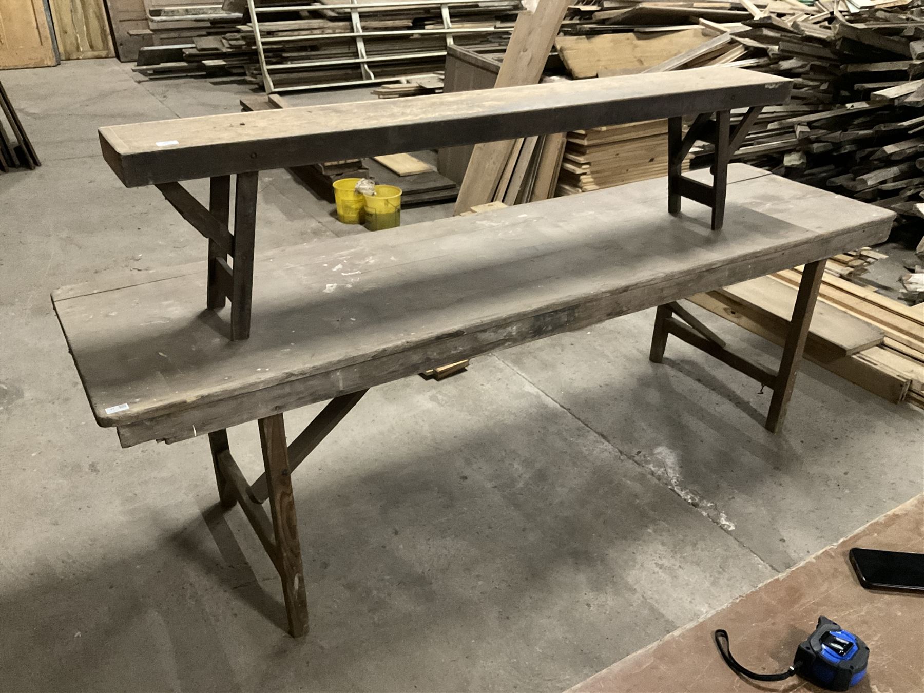 20the century pine folding table, rectangular top on square supports joined by stretchers (244cm x 68cm, H76cm); together with a similar folding bench (181cm x 25cm, H43cm) - THIS LOT IS TO BE COLLECTED BY APPOINTMENT FROM THE OLD BUFFER DEPOT, MELBOURNE PLACE, SOWERBY, THIRSK, YO7 1QY