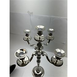 Pair of four branch candelabras, urn-shaped nozzles raised upon scroll branches supported from tapering central stem, with a stepped circular base, H59cm