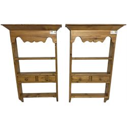 Pair of 20th century small waxed pine plate racks, shaped apron over three shelves and single drawer styled as two