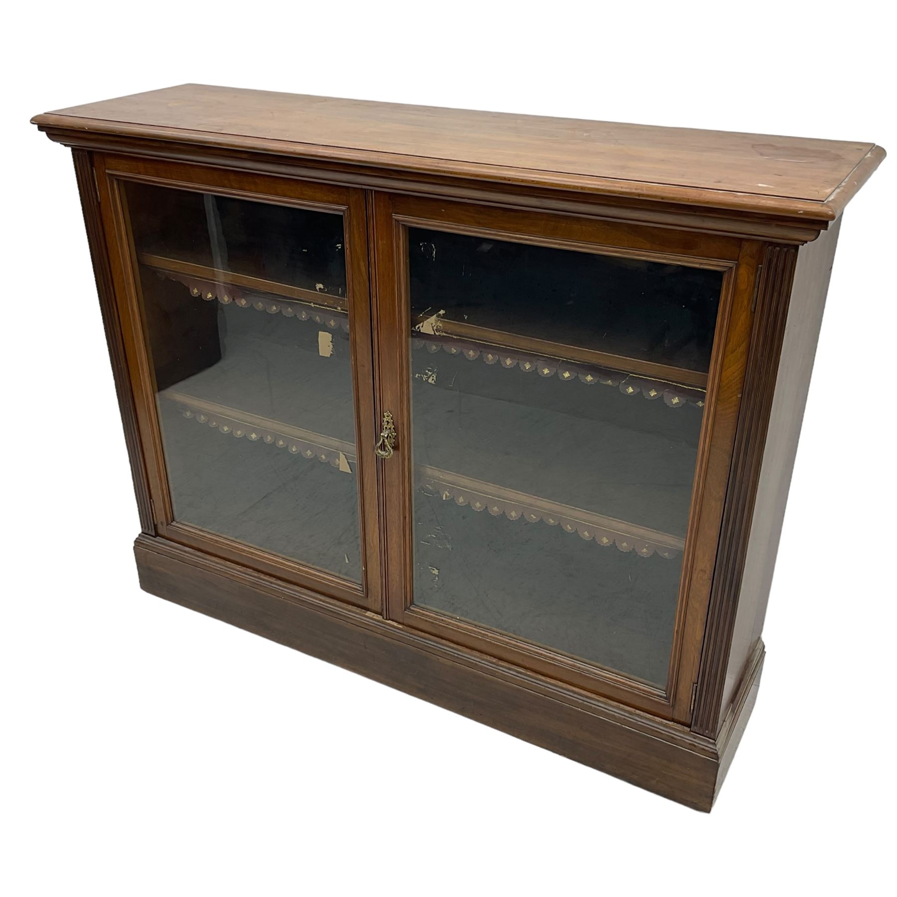 Phillips & Sons Ltd Bristol - Victorian mahogany glazed bookcase, projecting moulded cornice over two glazed doors, enclosing two shelves with scalloped edging, raised on a plinth base