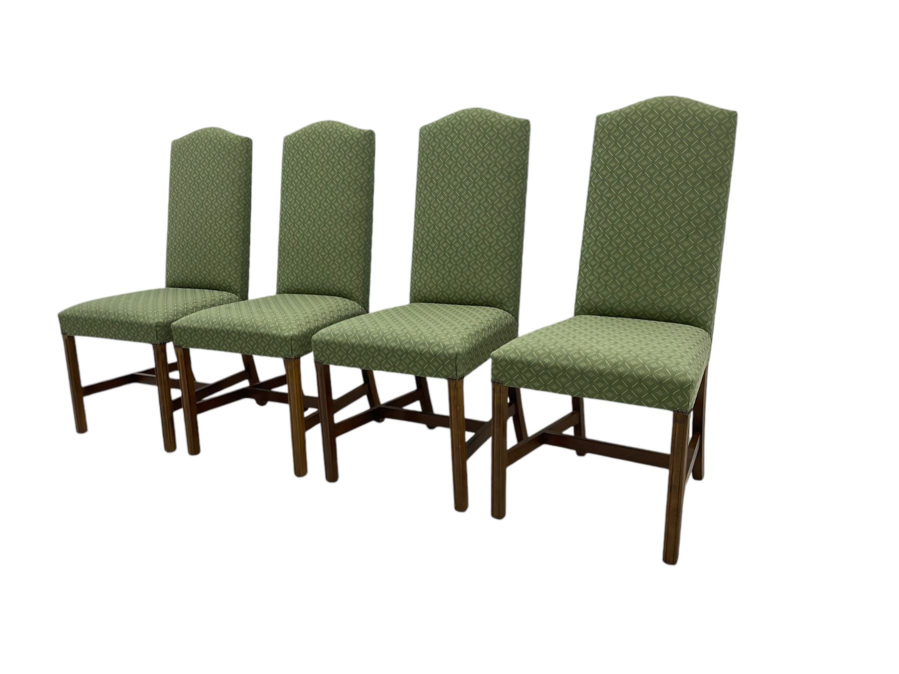 Early 20th century oak extending dining table, rectangular top with rounded corners, on turned baluster supports united by X-stretchers, fitted with a pull-out extending mechanism (106 x 142 - 228cm, H76cm); set of eight high-back dining chairs upholstered in green fabric with geometric diamond pattern