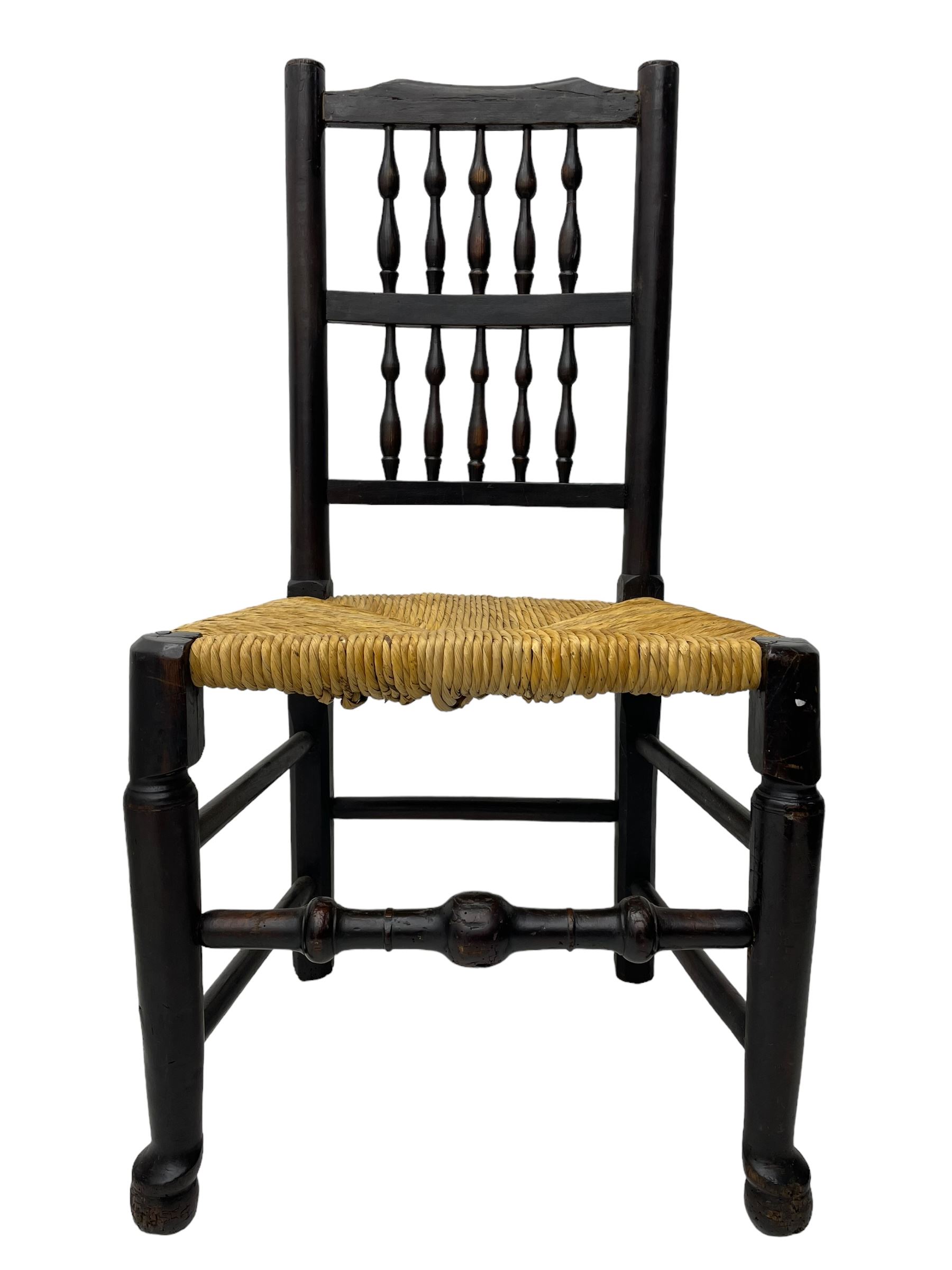 Matched set of twelve 19th century elm Lancashire spindleback dining chairs, shaped cresting rail over spindle back, rush seat, on turned supports united by turned stretchers, ring and globular turned front stretcher 