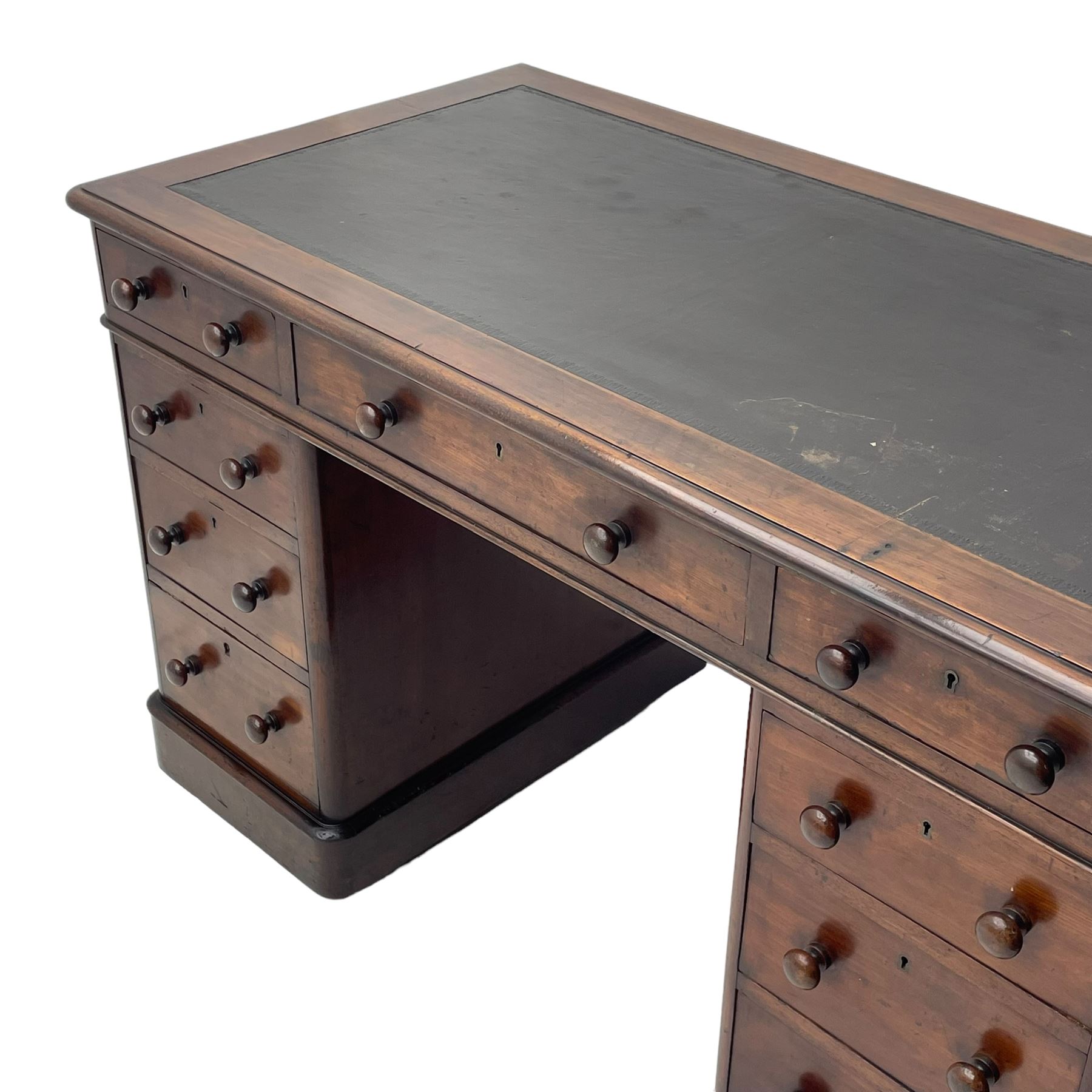 Victorian mahogany twin pedestal desk, moulded rectangular top with inset leather writing surface, nine drawers each fitted with two turned handles, on moulded plinth base 