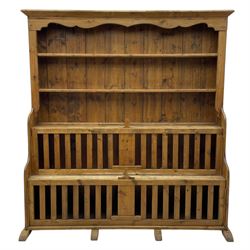 Waxed pine 'chicken coop' or 'hutch' dresser, projecting cornice over shaped frieze and three tier plate rack, the stepped waterfall lower section fitted with two slatted chicken coops, on sledge feet 