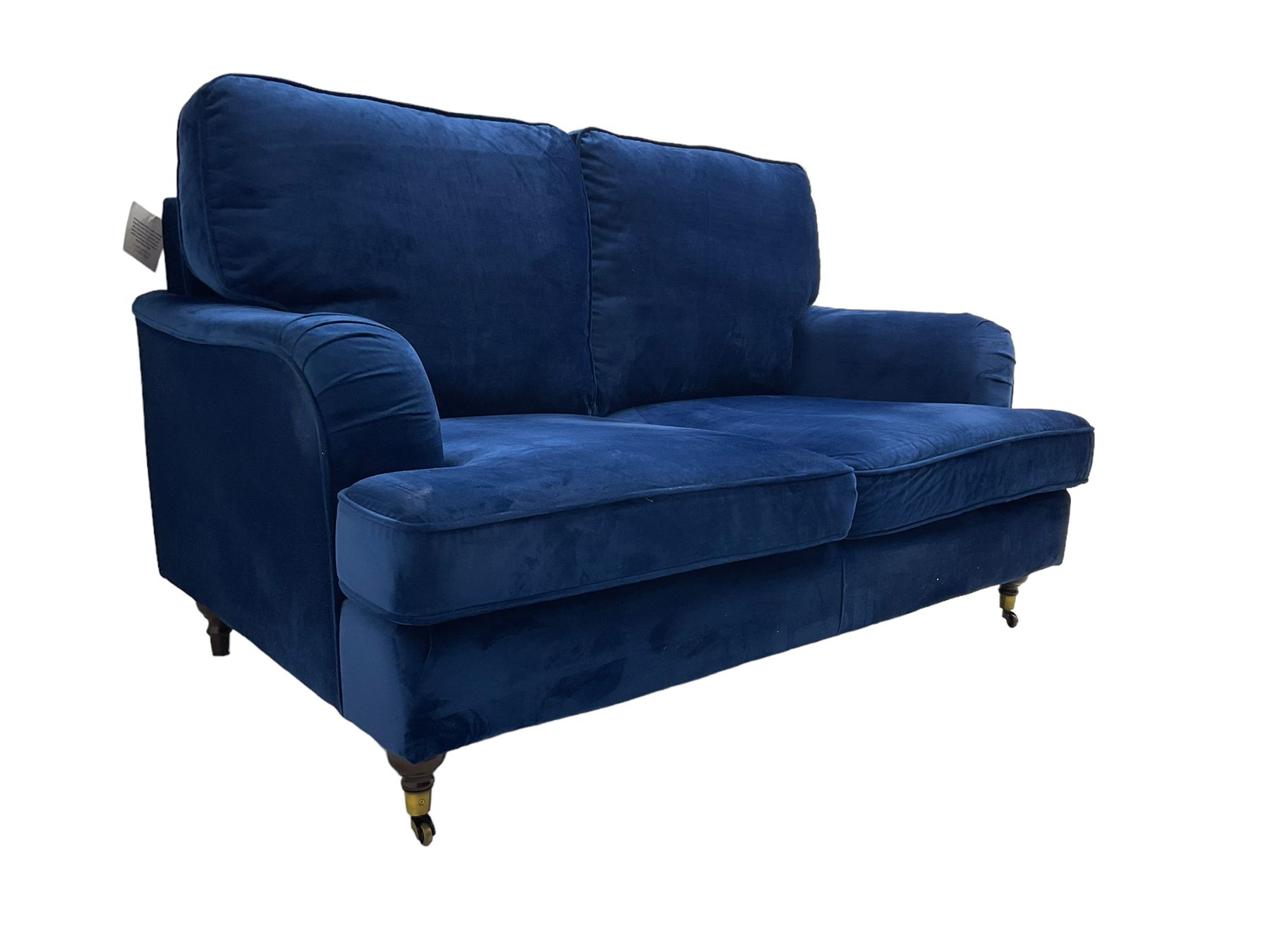 Howard design - two-seat sofa upholstered in blue fabric, traditional shape with rolled arms, on walnut finish turned feet with brushed metal cups and castors