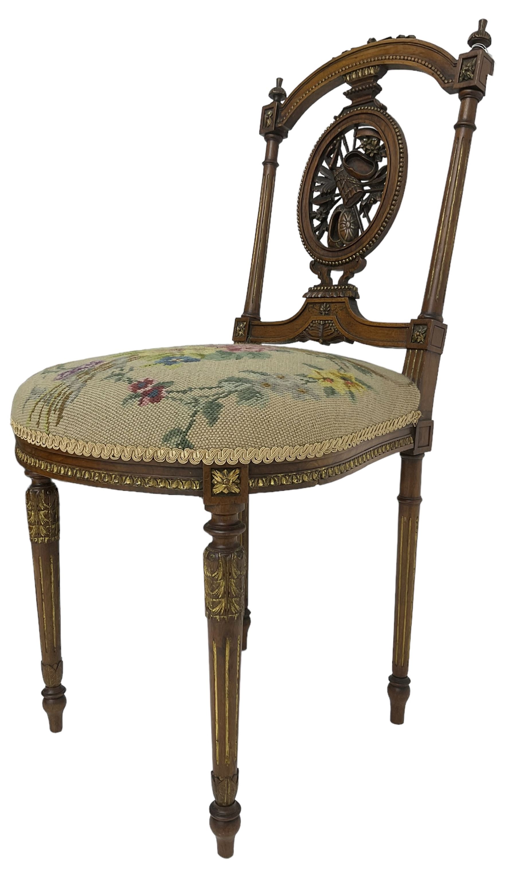 Late Victorian walnut side chair, arched cresting rail over carved and pierced splat depicting baskets and foliage, floral needle work upholstered seat, on acanthus carved and fluted turned supports