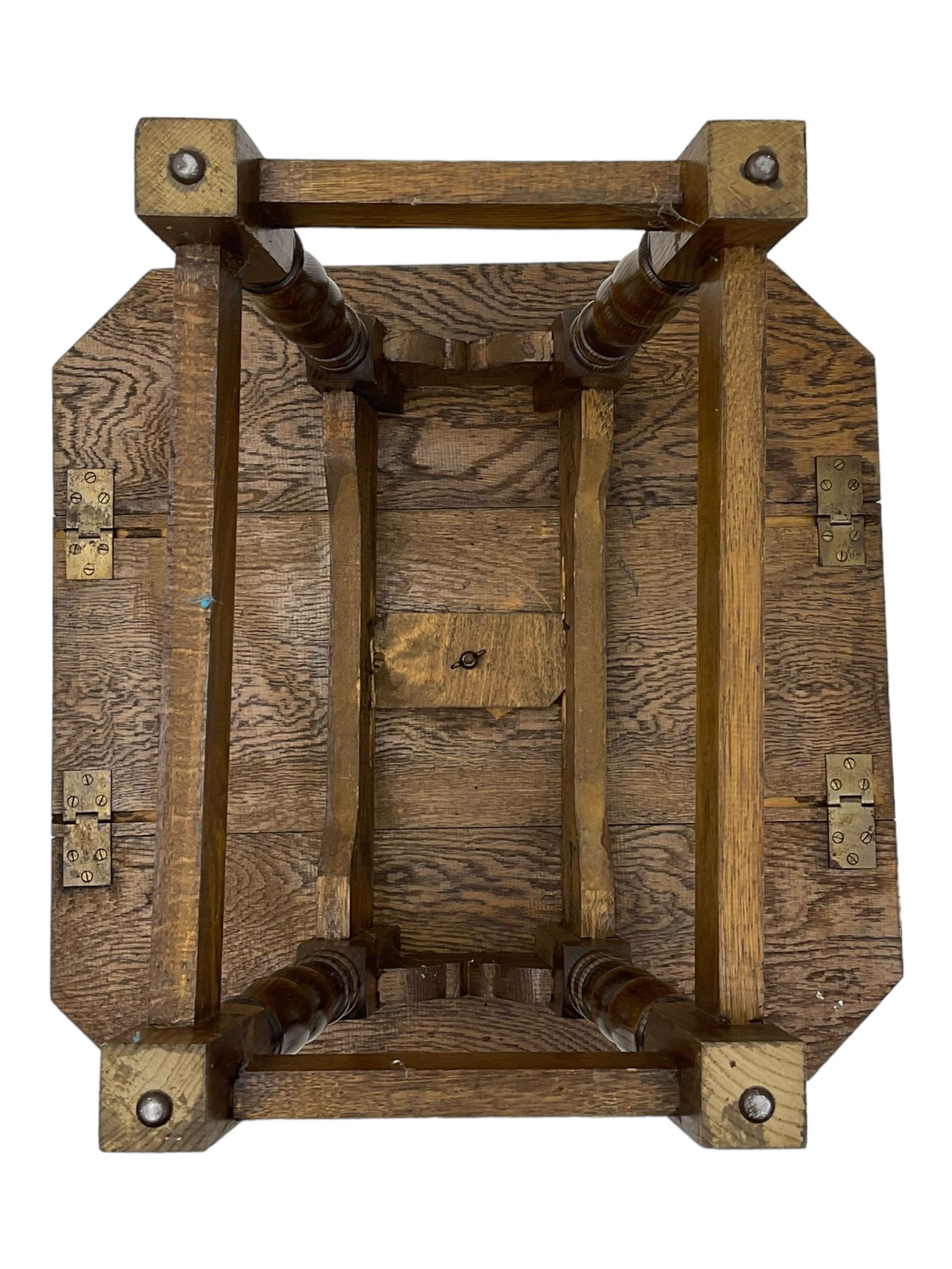 20th century oak drop-leaf table, bevel edged square top with cut corners, raised on splayed turned baluster supports united by stretchers