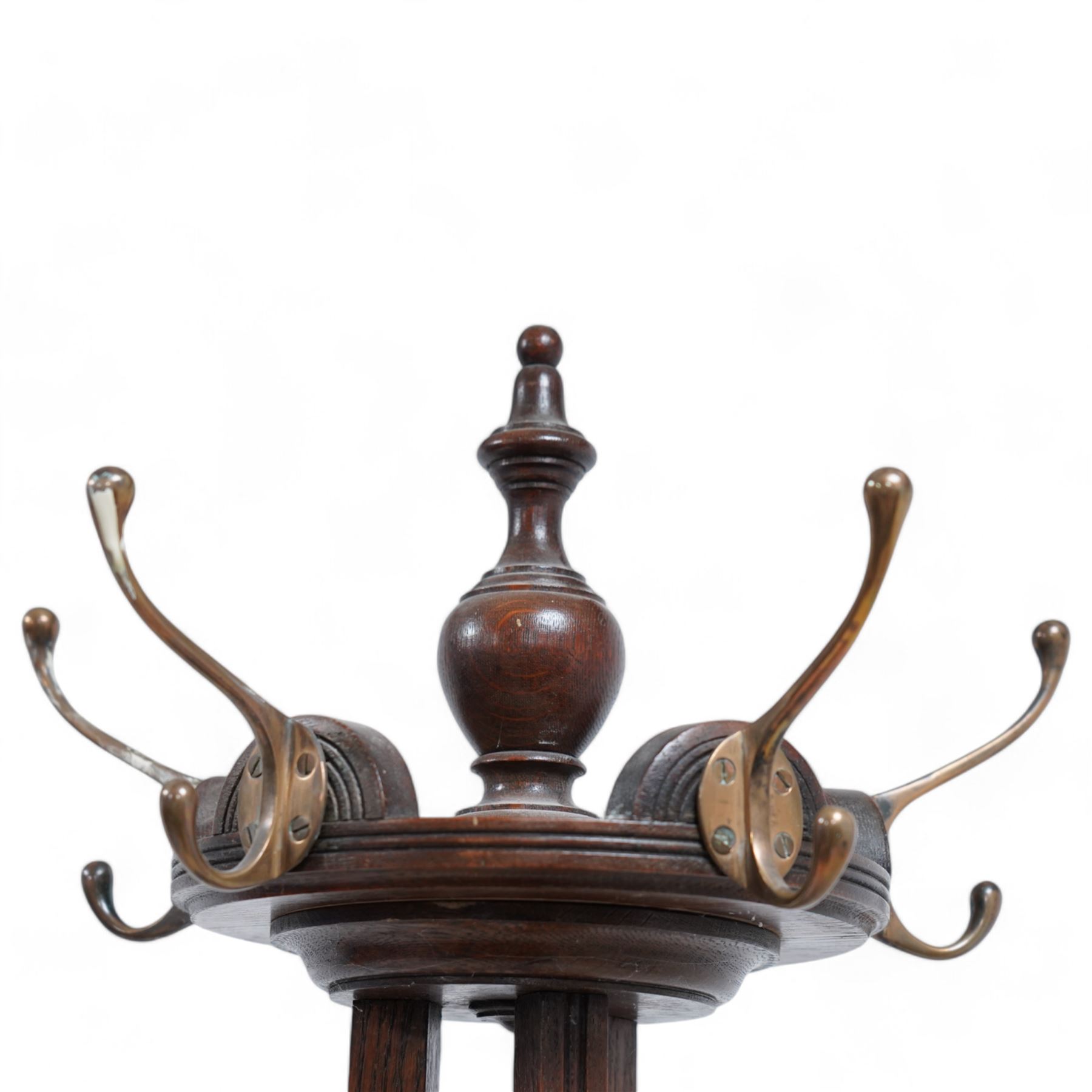 Late 19th century oak hat and coat hallstand, on three shaped and moulded supports with out splayed feet, fitted with hooks and turned finial 