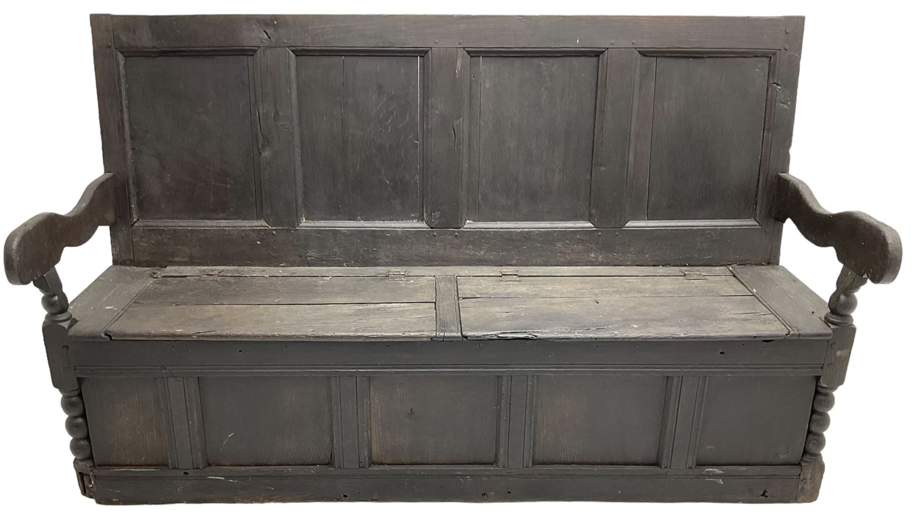 18th century oak box seat settle bench, pegged construction with quadruple panelled back over double hinged box seat, shaped projecting arms with scroll carved terminal detail, on block and bobbin turned front supports, panelled front within moulded frame