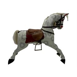 Mid 20th century rocking horse, dappled grey painted horse with applied mane and tail, red leather saddle and bridle accented with brass studs, supported by a stained wooden frame with turned supports and iron brackets, mounted on rockers