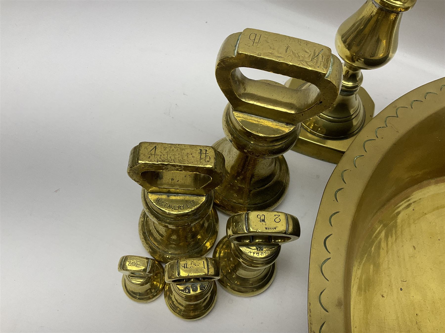 Collection of early 20th century and later brass, to include a large bowl with punched decoration to rim, pair of candlesticks, inkwell, weights, horse brasses, etc 