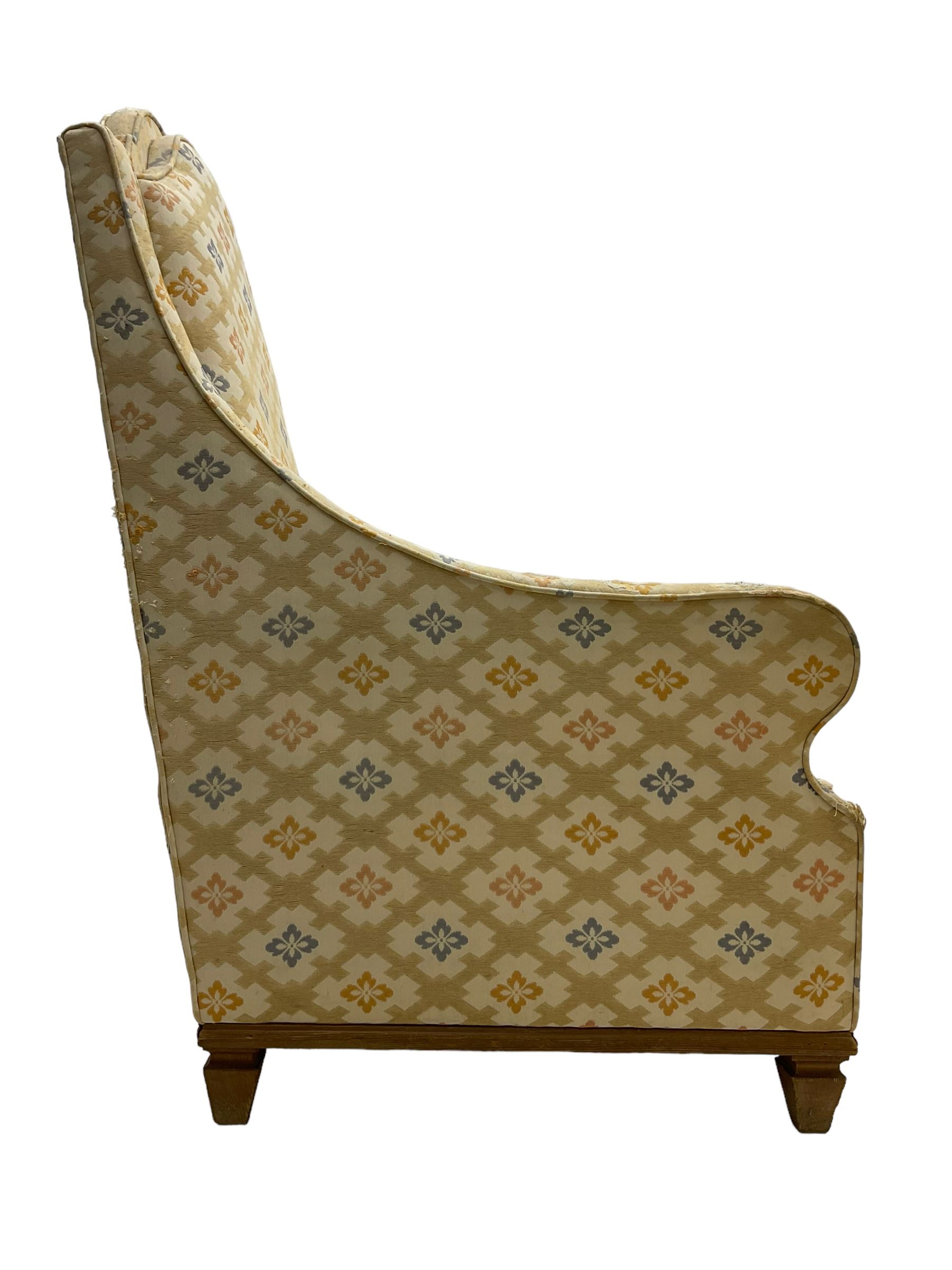 Spanish high back throne armchair, arched cresting rail over scooped arms, upholstered in gold and ivory patterned fabric, on a pitch pine base with spade feet