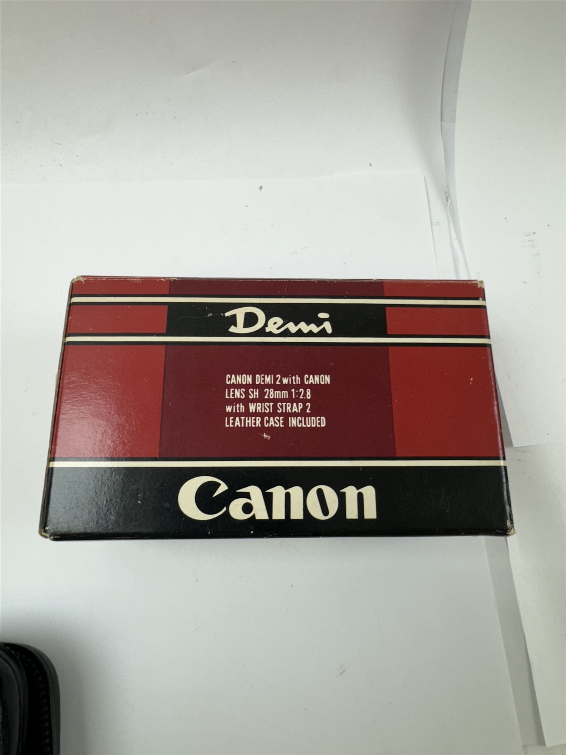 Three Canon half frame cameras, comprising two Canon Demi examples, serial nos. 243090 & 704714, one example boxed, and a Canon Dial35 serial no. 341572