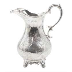 Victorian silver jug, of waisted form with C scroll handle, the body engraved with strapwork panels and circular cartouches, upon four embossed feet, hallmarked Charles Boyton, London 1864, H15.5cm