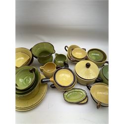 French green and yellow glazed tea and dinner wares by Etienne Noel, including milk jugs, teacups, side plates, bowls etc (43)