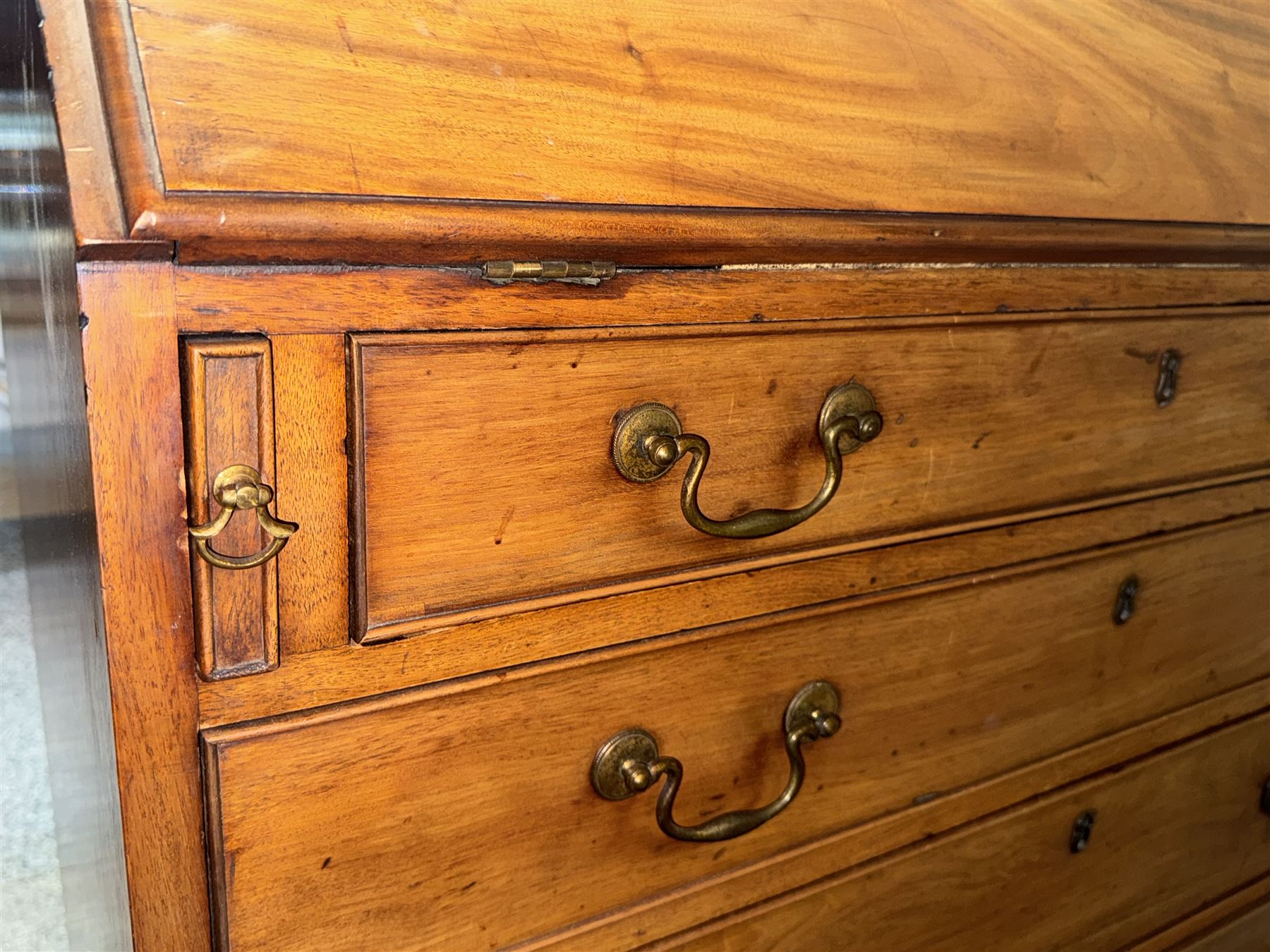 Georgian mahogany bureau, moulded fall front enclosing cupboard, small drawers, pigeonholes and inset writing surface, fitted with four long graduating cock-beaded drawers, on splayed bracket feet 