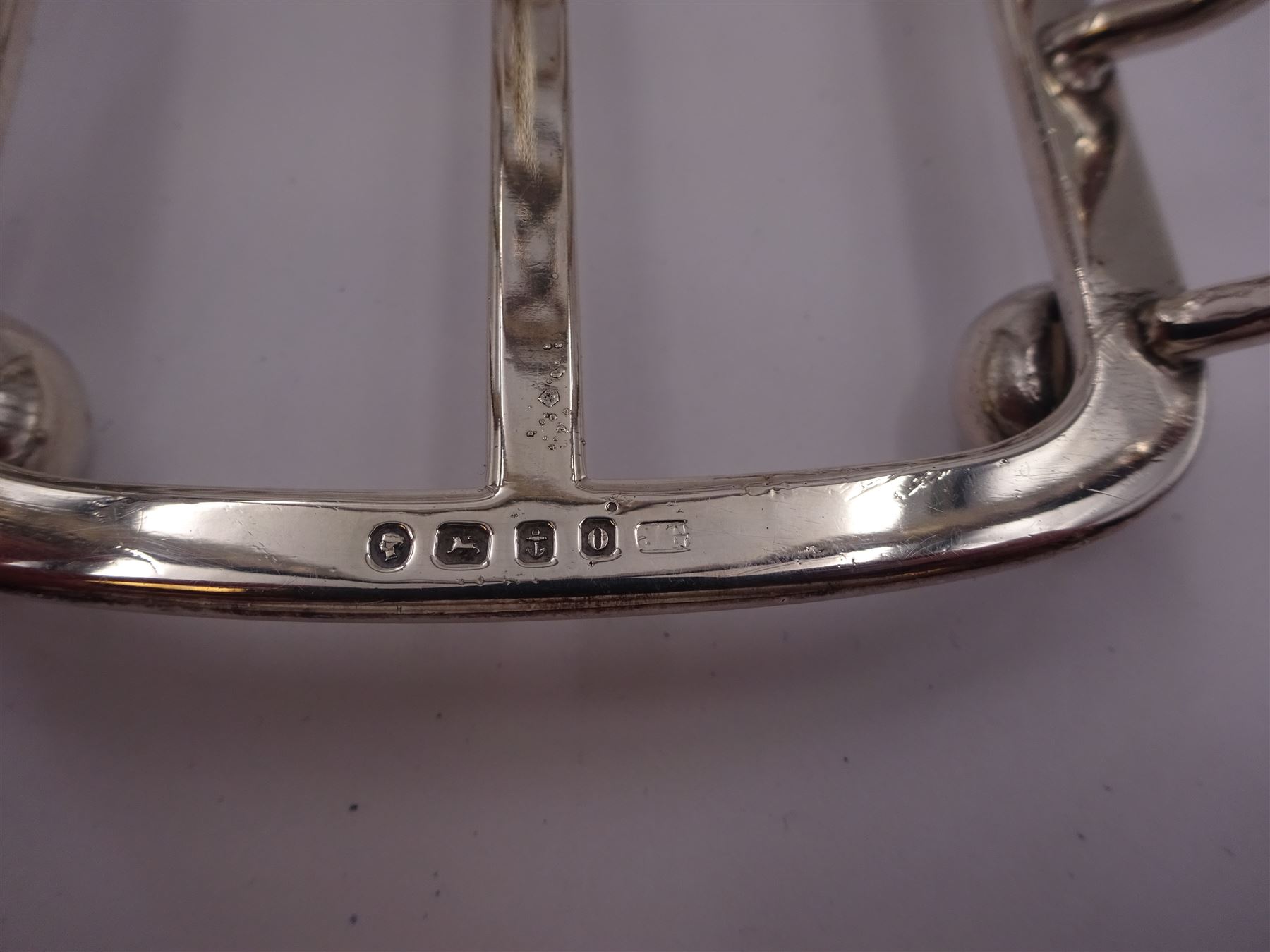 Victorian silver seven bar toast rack, each bar of trilobed form, with similar loop handle and upon four bun feet, hallmarked John Gilbert, Birmingham 1863, H16.5cm