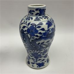 Pair of late 19th/early 20th century Chinese blue and white vases, each of baluster form, painted with dragons amidst flowers, each with Kangxi character marks beneath, H14cm 