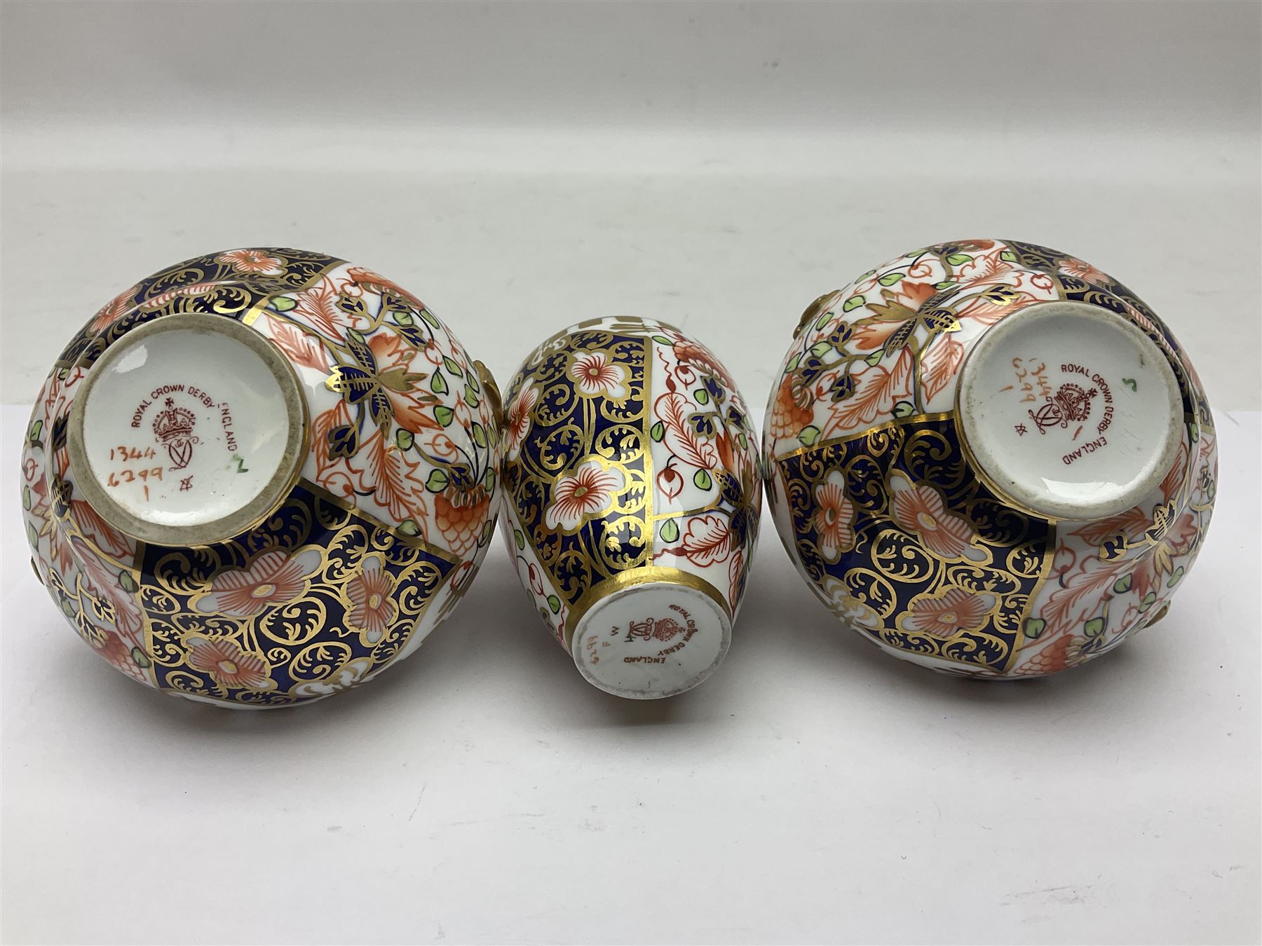 Pair of Royal Crown Derby 6299 imari miniature two-handled vases, together with another miniature vase of baluster form, all with printed mark beneath, tallest H8cm 