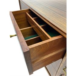 Mid 20th century teak sideboard, rectangular top with rounded corners over three central drawers, flanked by two cupboard doors enclosing shelves, raised on tapered supports