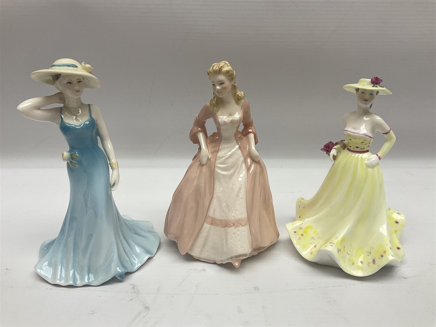 Three Royal Doulton figures, comprising Anna HN4391, Kirsty HN2381 and Deborah HN4468, together with a similar Coalport figure and ten smaller Coalport figures (14)