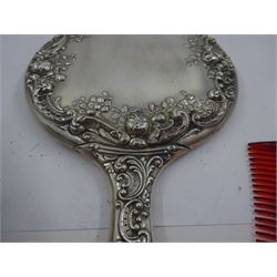 American silver mounted three piece dressing table set, comprising hand mirror, hairbrush and comb, each embossed with flowers and C scrolls, stamped Gorham Sterling