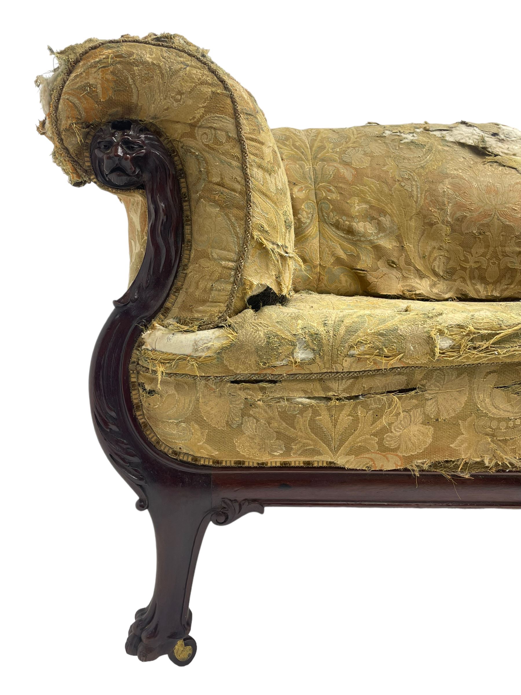 19th century mahogany settee, rolled S-scrolled arms carved with lion masks and acanthus leaf scrolls, the lower moulded rail carved with scrolling design, raised on carved paw feet with recessed brass and ceramic castors 