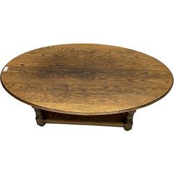 Traditional oak coffee table, moulded oval top, four turned pillar supports united by undertier