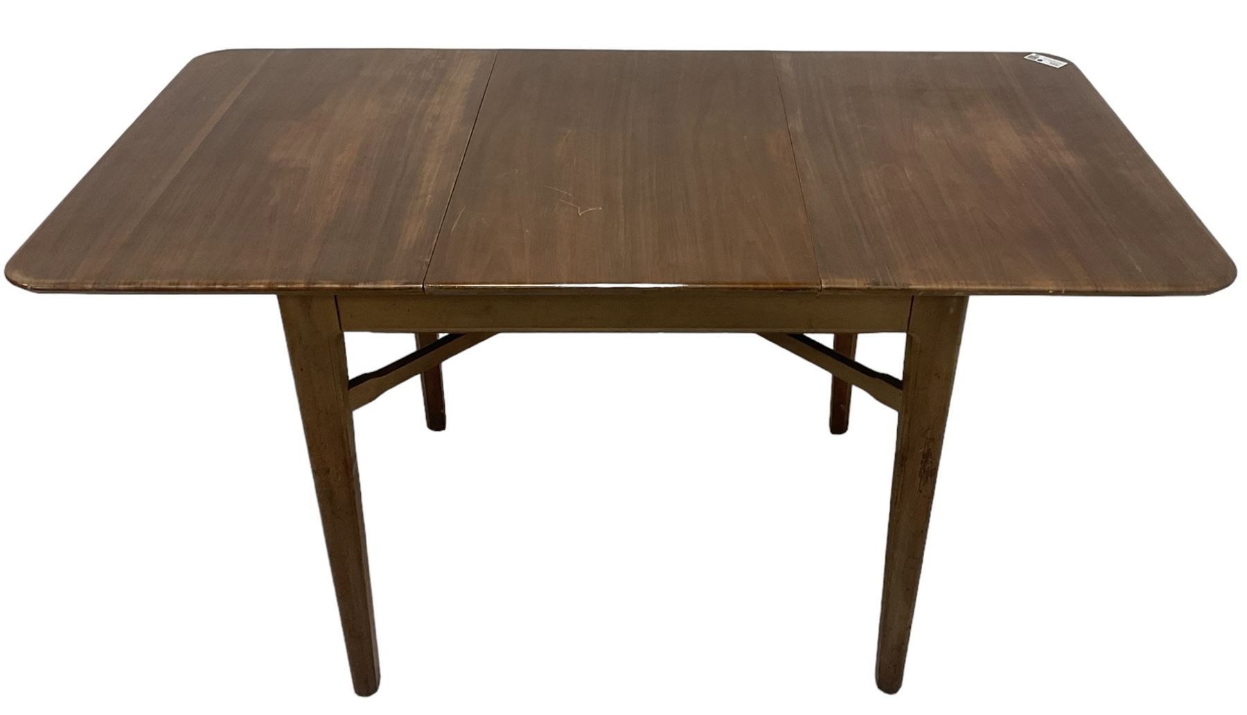 Mid-20th century teak extending dining table, rectangular top with rounded corners, raised on shaped tapering supports united by X-stretcher, with additional leaf