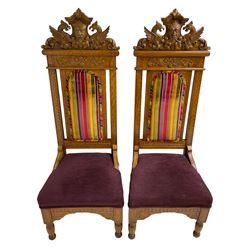 Set of six 20th century Carolean design oak high back chairs, the pediment carved with dragons and central Green Man mask with trailing foliage, the backs upholstered in striped fabric, on turned front supports