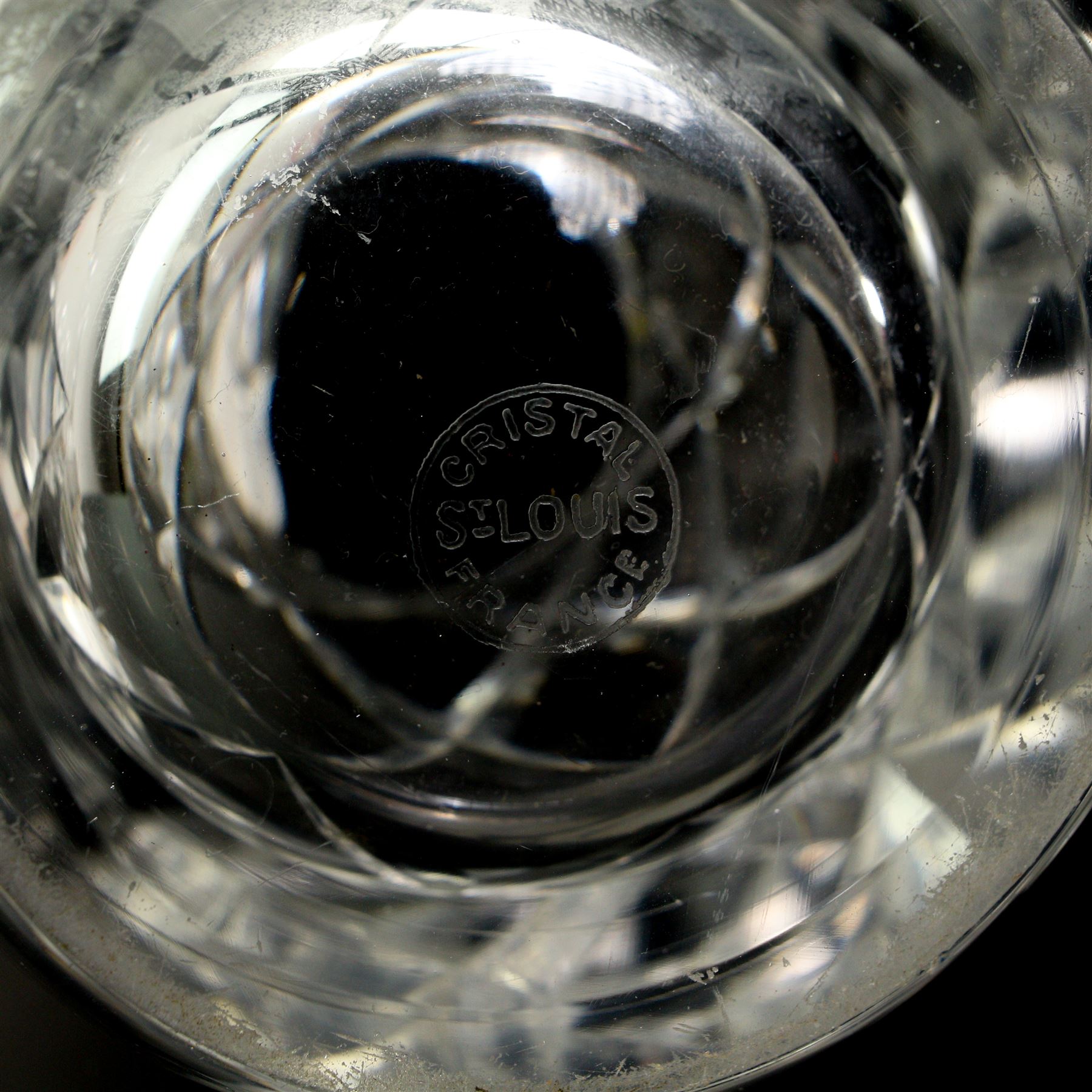 Part suit of Stuart Ariel drinking glasses comprising eight champagne flutes, six white wine glasses and two red wine glasses, together with a Saint Louis heavy cut glass vase, H25cm