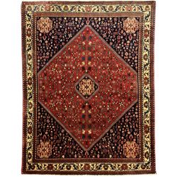 South West Persian Abadeh crimson ground rug, indigo ground with crimson lozenge field, decorated all over with small stylised motifs of flowerheads, hooks, animals and birds, guarded border decorated with trailing leaves and stylised plant motifs 