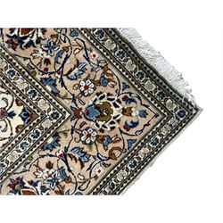 Persian Kashan ivory ground rug, central floral medallion surrounded by interlacing leafy branches and stylised plant motifs, scrolling spandrels, the border decorated with trailing branch and repeating palmettes, within floral pattern guard stripes 