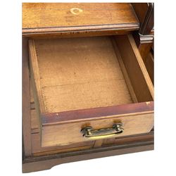 Victorian walnut clerk's desk, raised central section with tambour roll over hinged top, the interior fitted with leather inset writing surfaces, small drawers, document divisions and pen and ink stand, central drawer over double panelled cupboard, flanked by two banks of four graduating drawers, on bracket feet 