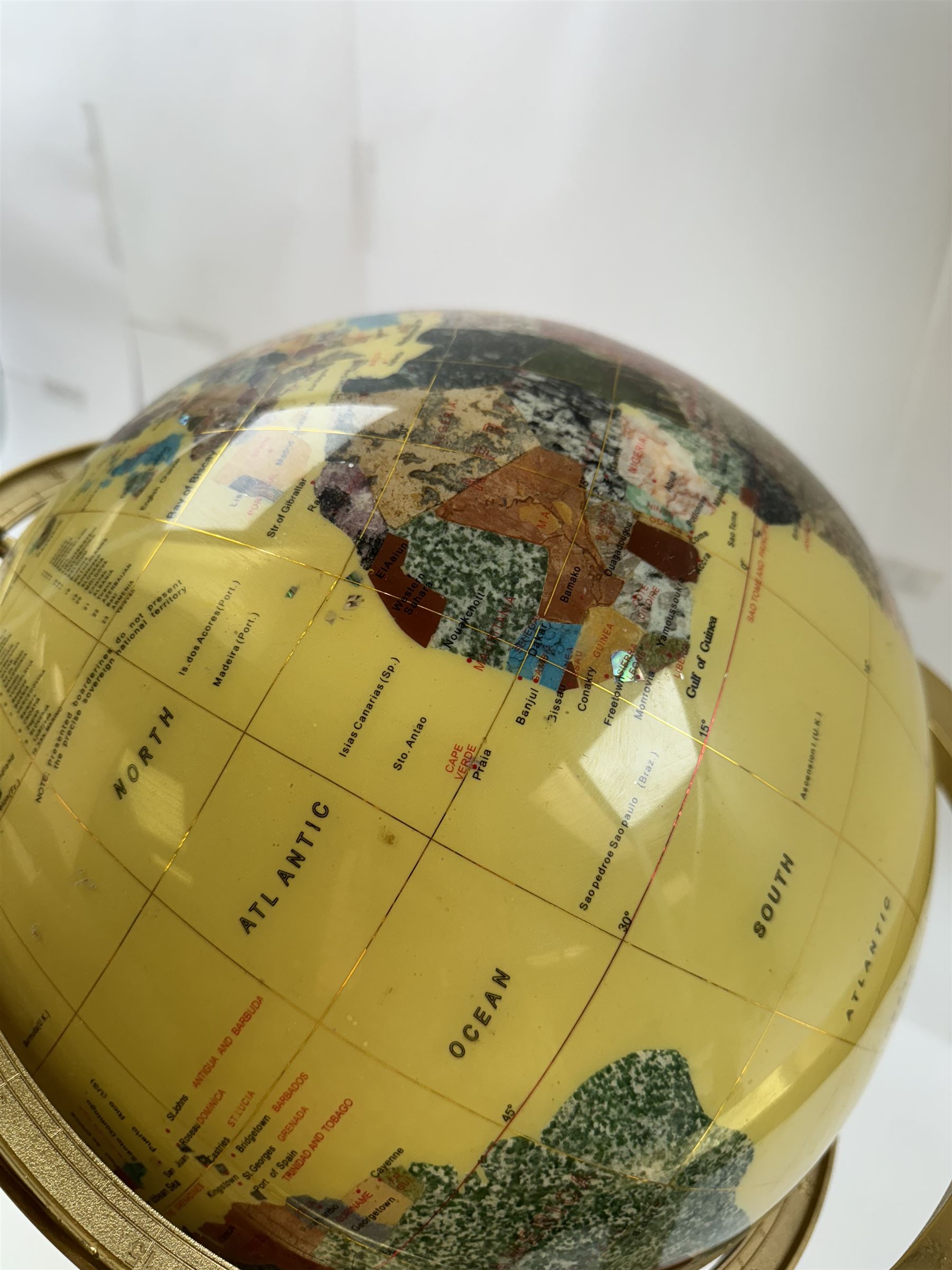 Polished gemstone terrestrial globe on gilt metal stand, H47cm