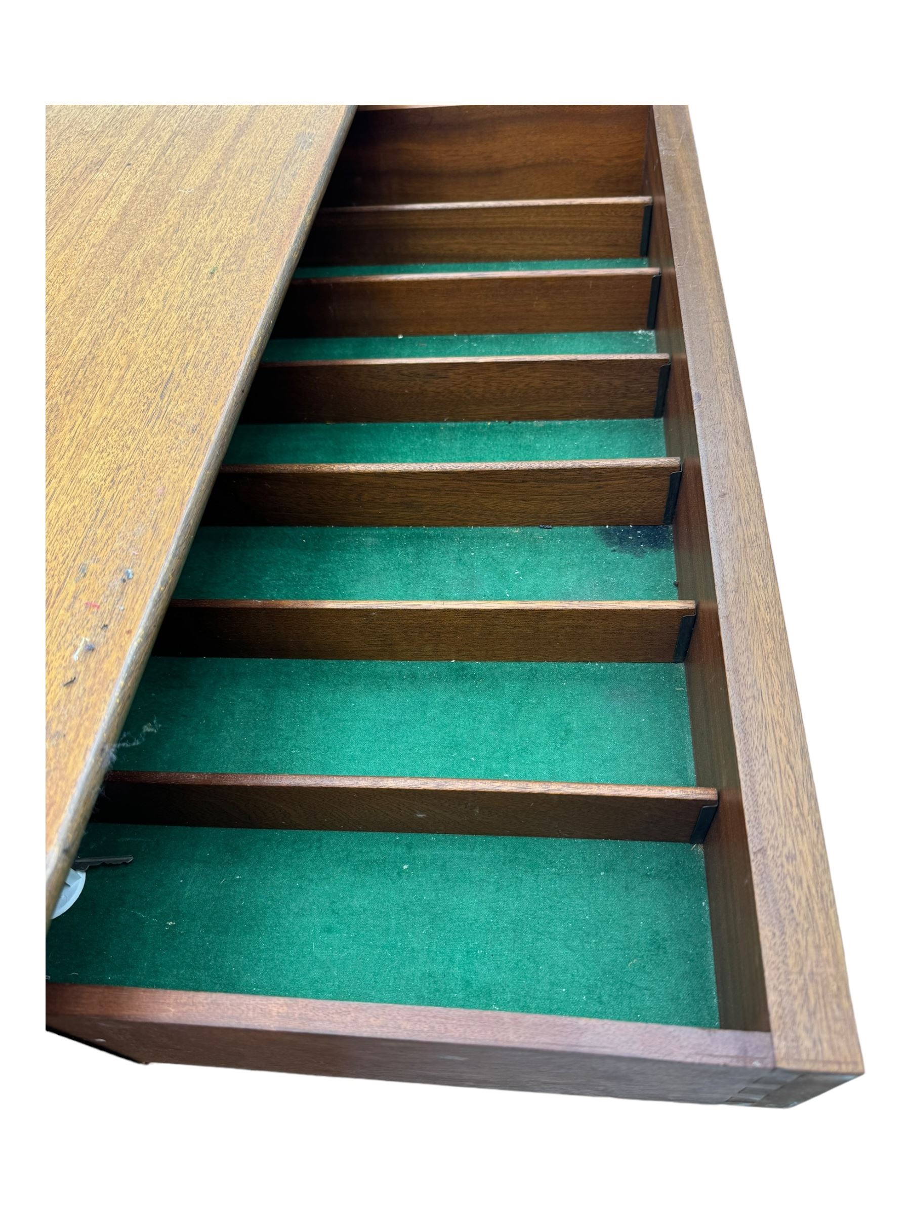 Younger - mid-20th century teak sideboard, rectangular top over three central drawers with recessed handles, flanked by two cupboard doors enclosing two shelves, on tapered supports joined by stretchers