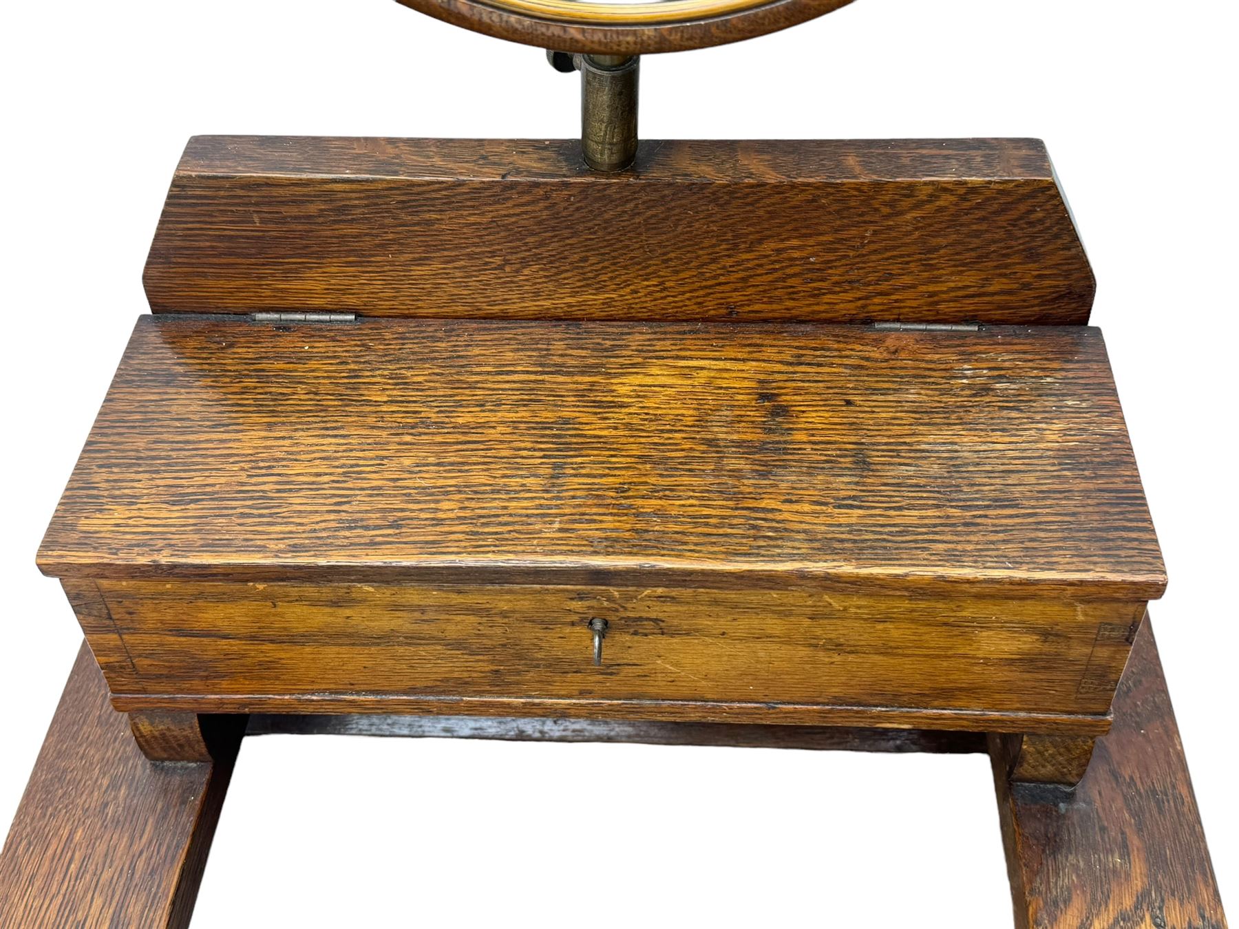 Early 20th century oak vanity stand, with circular adjustable mirror, brass towel rails to the sides, marble inset top and upper compartment, over additional storage compartment with hinged front, on splayed supports with stretchers