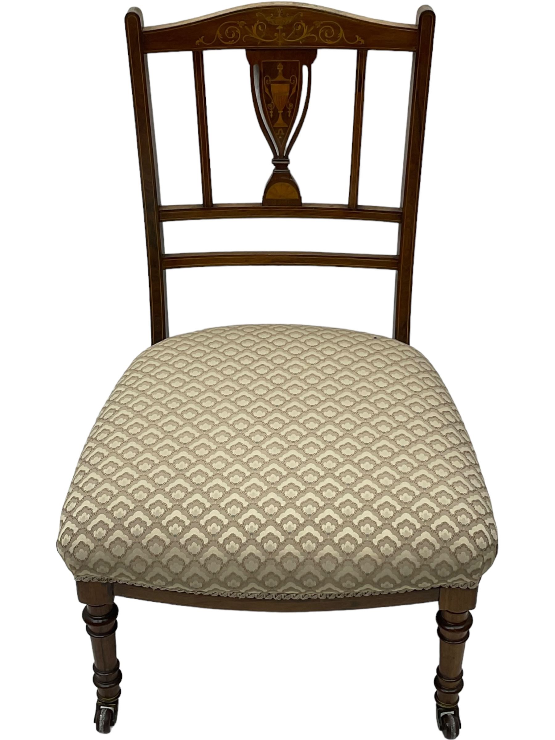 Early 20th century mahogany side chair, detailed marquetry frame, backrest with central urn motif and scrollwork inlay, arched crest rail with floral designs, cream and gold patterned fabric seat, turned front legs with brass castors (H78cm); Victorian walnut nursing chair, carved crest rail, floral needlepoint tapestry upholstery, turned front legs with ceramic castors (H81cm)