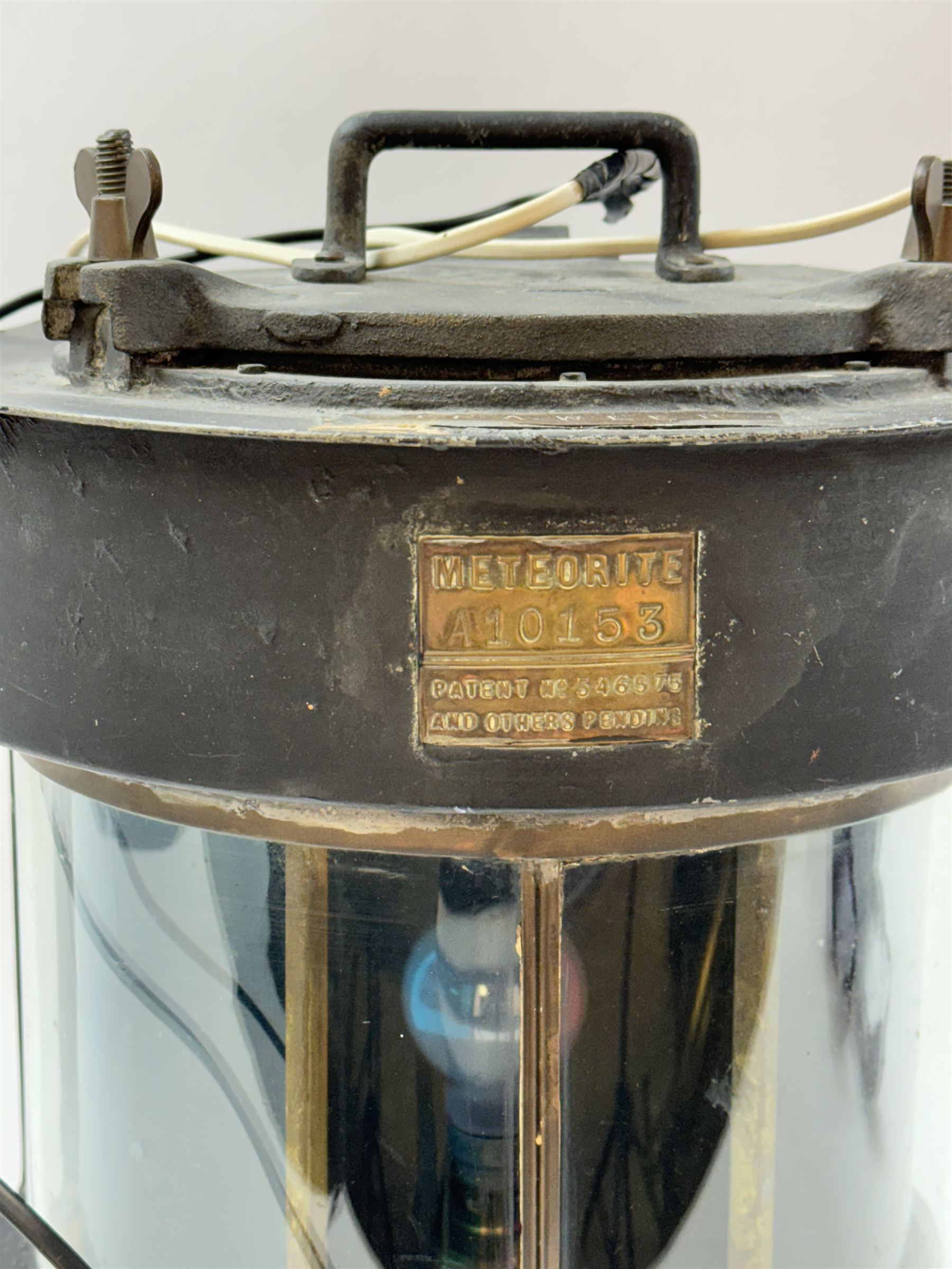 Meteorite ship's lamp converted to electricity, painted in black matte finish, with applied brass plaque inscribed 'Trawler' and a further plaque inscribed 'Meteorite A10153', H42cm