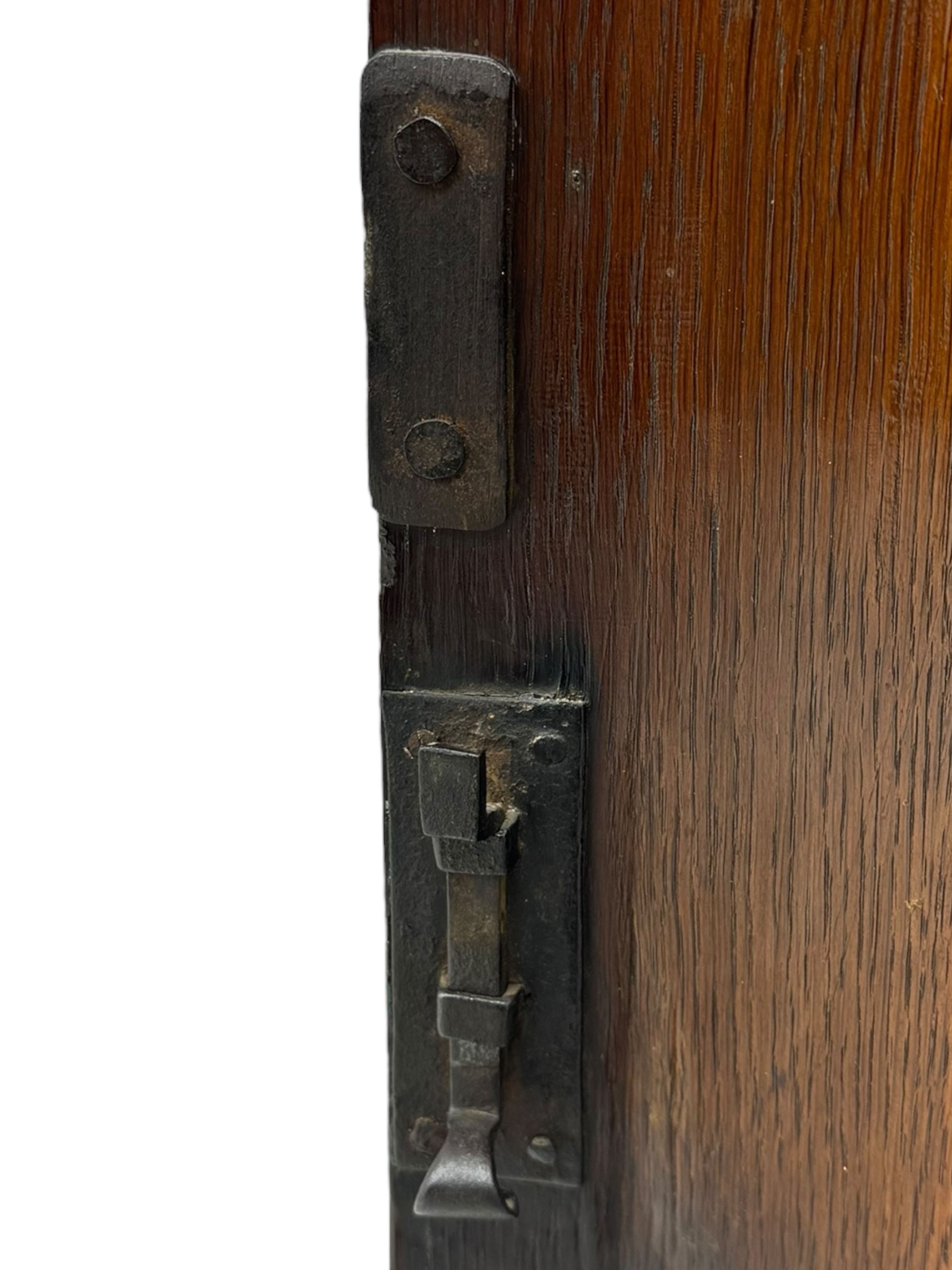 Georgian oak corner cabinet, projecting cornice with shaped dentil frieze, over two panelled doors enclosing three shelves, on a plain plinth base