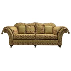 Steed Upholstery Ltd. - 'Lincoln' three-seat sofa upholstered in gold 'Olympia' floral pattern corded and tasselled fabric, together with scatter cushions and arm covers, on turned feet with brass castors