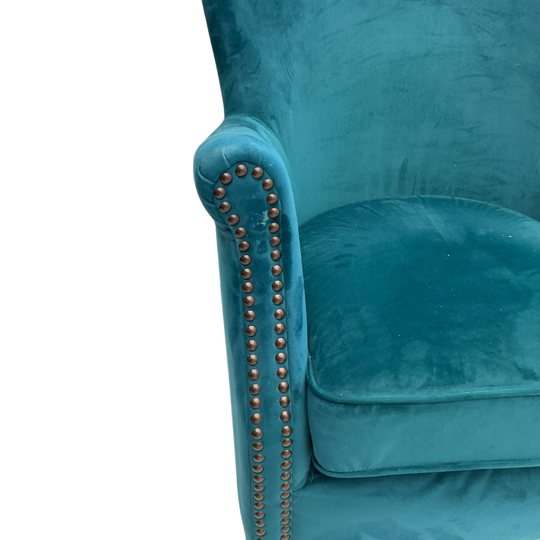 Contemporary tub-shaped armchair, upholstered in teal blue fabric, with high back and rolled arms accented with brass studded trim, on square tapered front feet