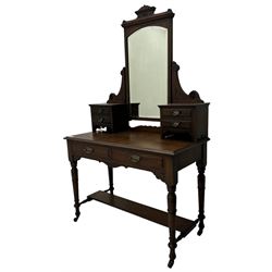 Late Victorian walnut dressing table, raised bevelled swing mirror over small trinket drawers, rectangular moulded top, fitted with two drawers, on turned supports united by undertier 