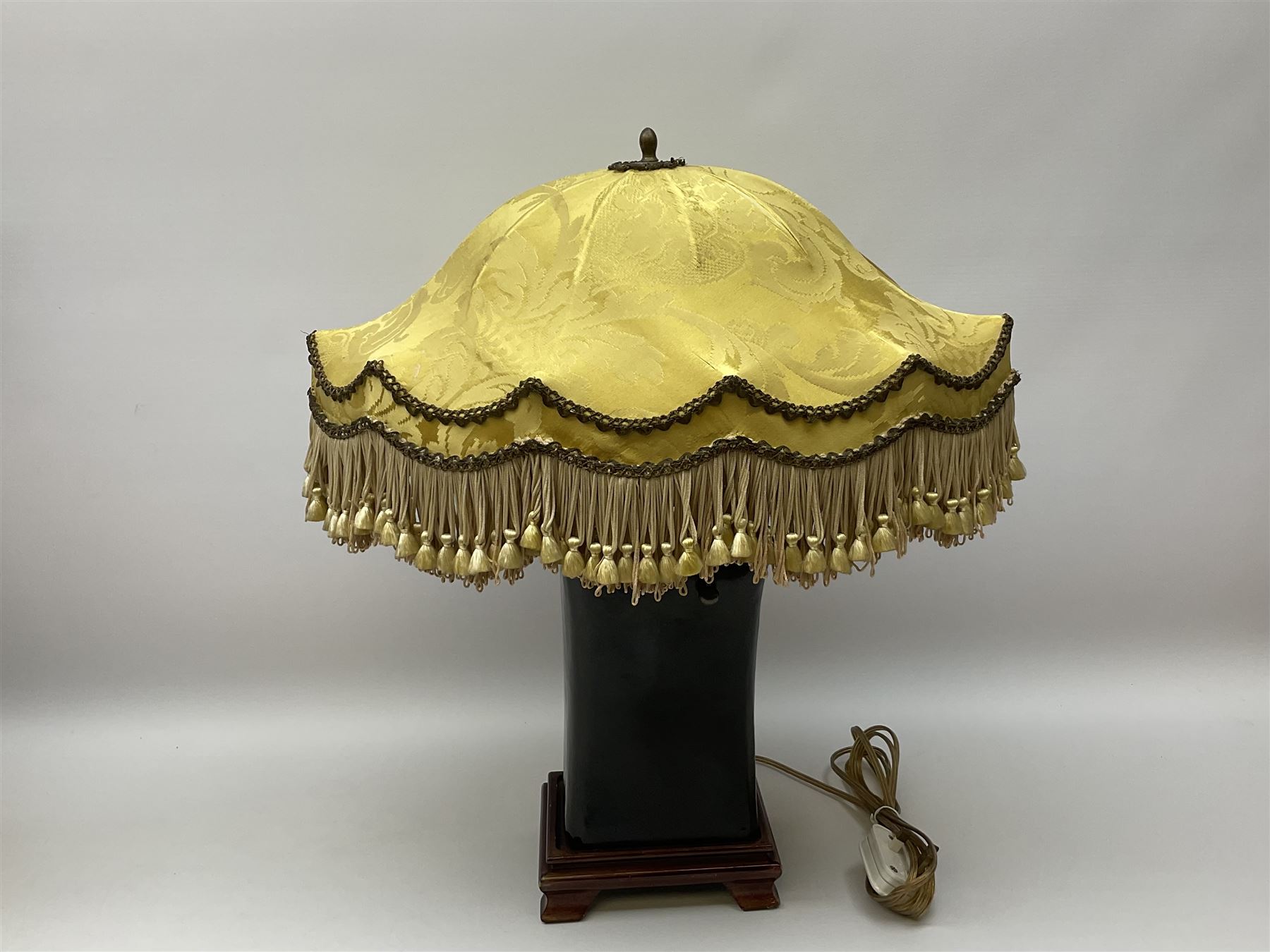 Blanc de Chine style table lamp with pierced foliate decoration, on a hardwood base, with a blue fabric shade, H36cm, together with black lacquered Chinese headrest, converted into a lamp, on a hardwood base, with yellow oval shade with tassels H50cm. .  